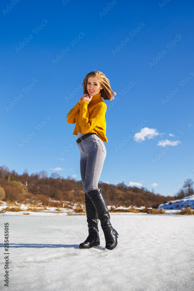 Girl in a yellow sweater and short haircut on the ice of the river. Girl in a yellow sweater and short haircut on the ice of the river.