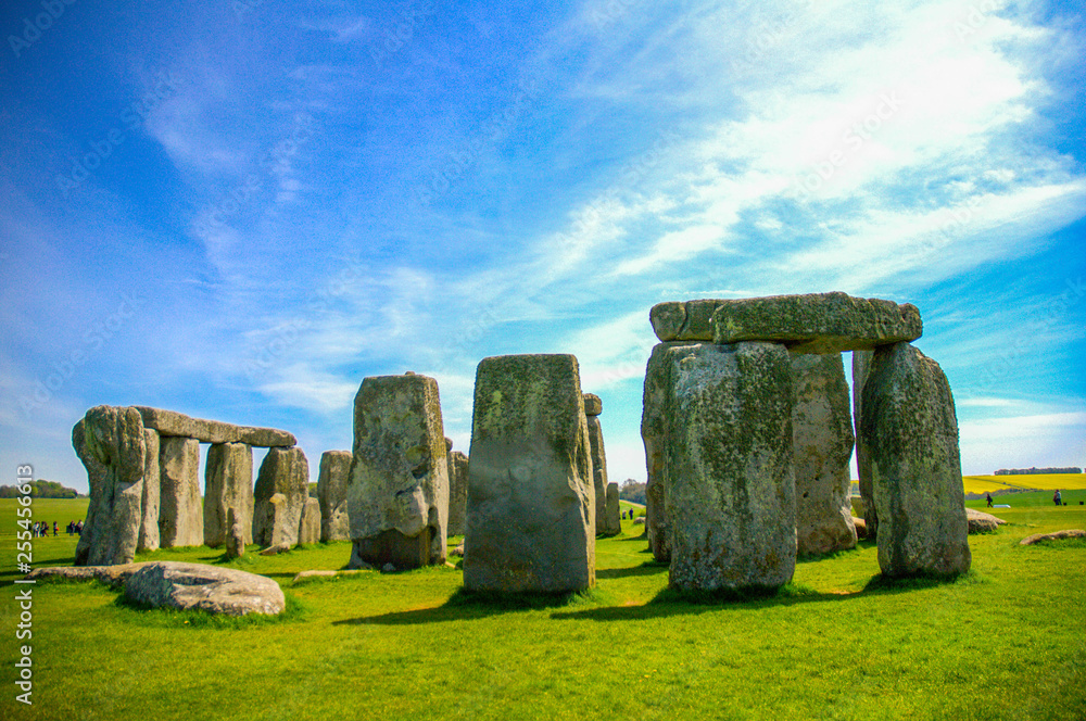 Naklejka premium Travel England, United Kingdom. Popular tourist destination in Europe. The ancient monument, famous, mysterious Stonehenge attraction. Sunny day, blue sky. Travel/outdoor background.