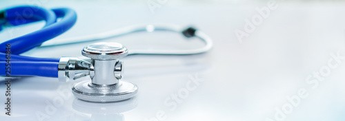 Stethoscope or phonendoscope on a doctor's white desk. Treatment of cold or flu, banner size