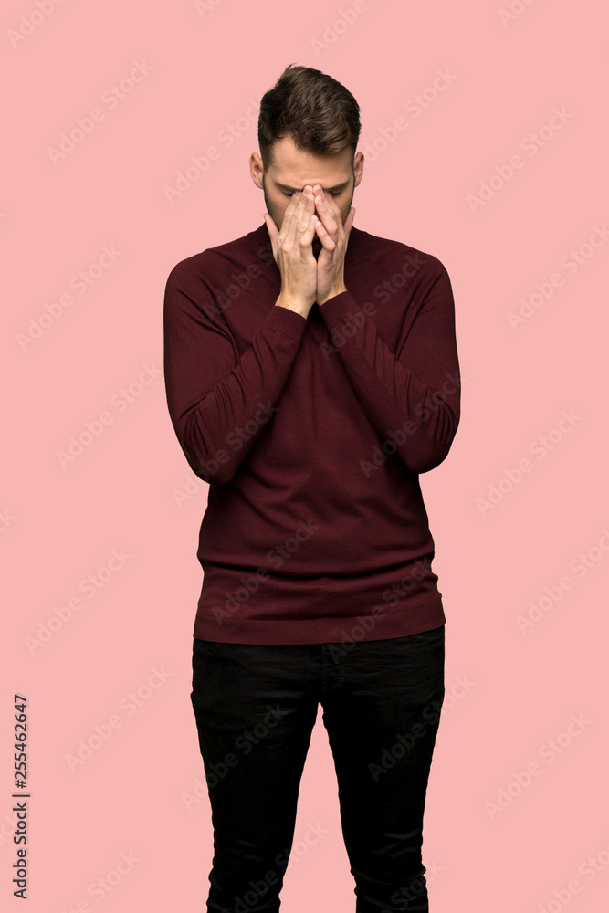 Man with turtleneck sweater with tired and sick expression over pink background Man with turtleneck sweater with tired and sick expression over pink background