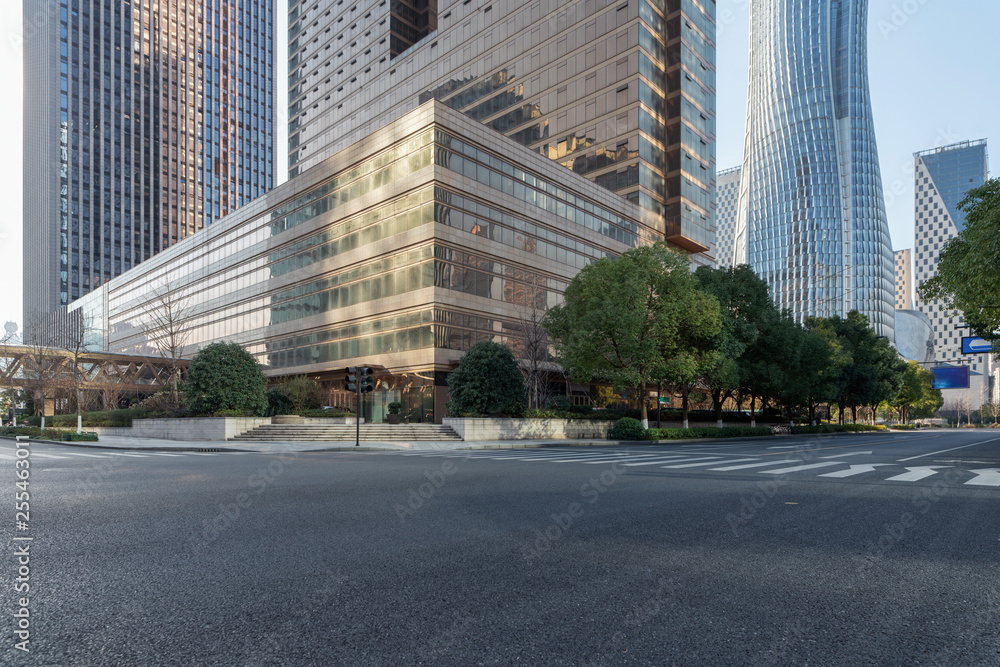 Empty asphalt crossroad and  modern office buildings in downtown  - obrazy, fototapety, plakaty 
