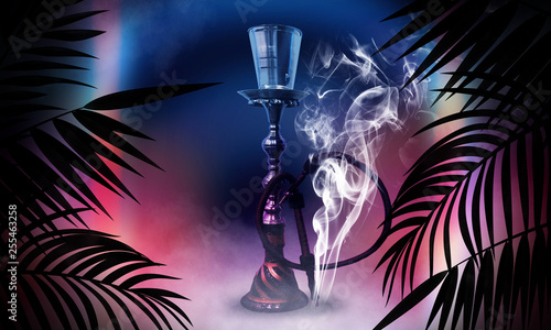 Hookah on the background of neon lamps and tropical leaves