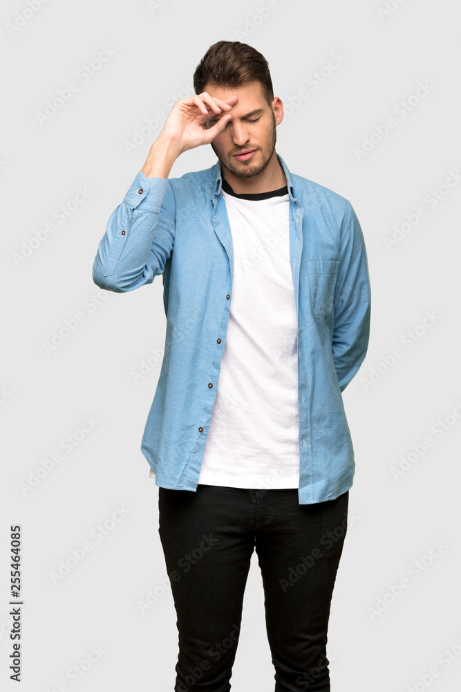 Handsome man with tired and sick expression over grey background Handsome man with tired and sick expression over grey background