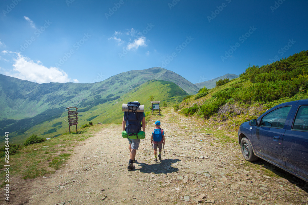Father and child together on mountain range park trail