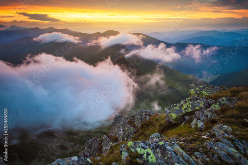 Above the clouds mountain sunset landscape in Romania