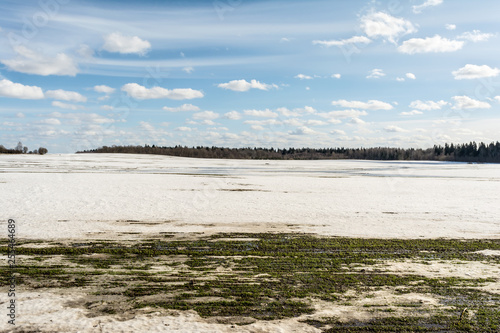 thawed patch on the field, snowy outdoor soccer field in spring low season