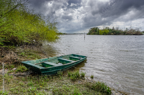 View of the river with grass and boat, in Porto do sabugueiro, muge, santarem portugal.