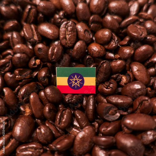 a Ethiopia flag placed over roasted coffee beans