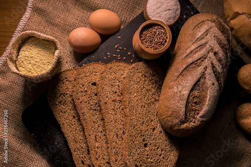 bread with cumin seeds flax dark board kitchen cooking table dark taste aroma salt flour bag