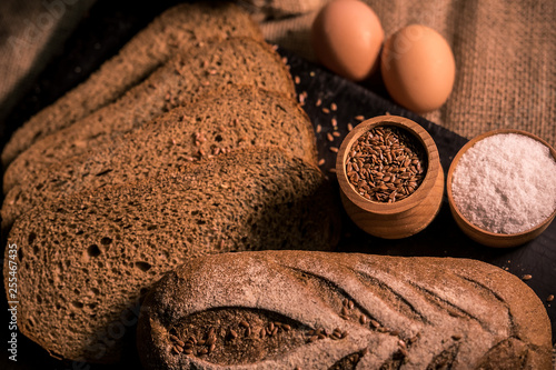 bread with cumin seeds flax dark board kitchen cooking table dark taste aroma salt flour bag