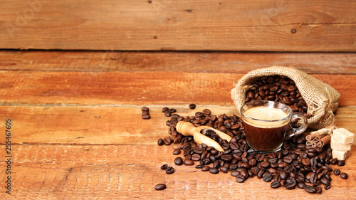 Coffee cup with Coffee beans, burlap sack and with cinnamon sticks