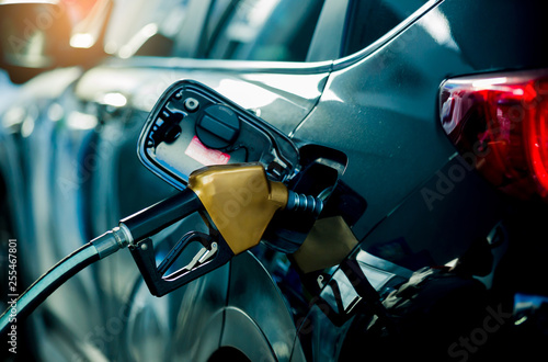 Hand refilling the car with fuel at the refuel station