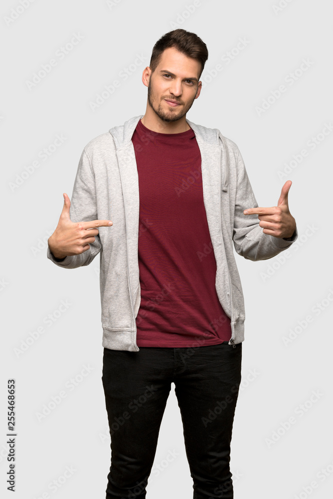 Man with sweatshirt proud and self-satisfied over grey background Man with sweatshirt proud and self-satisfied over grey background