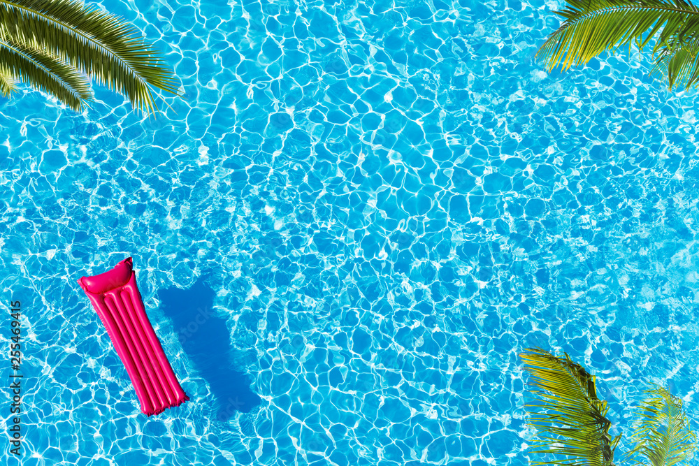 Vacation pool with matrass surface and palm trees - obrazy, fototapety, plakaty 