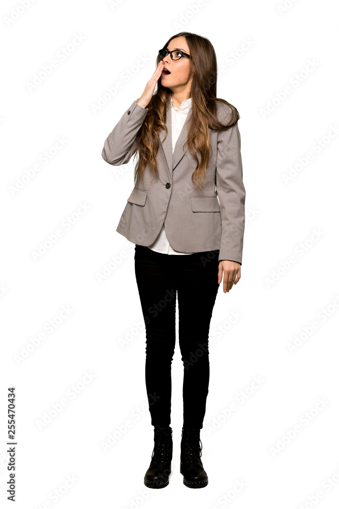 Full-length shot of Business woman yawning and covering wide open mouth with hand on isolated white background Full-length shot of Business woman yawning and covering wide open mouth with hand on isolated white background
