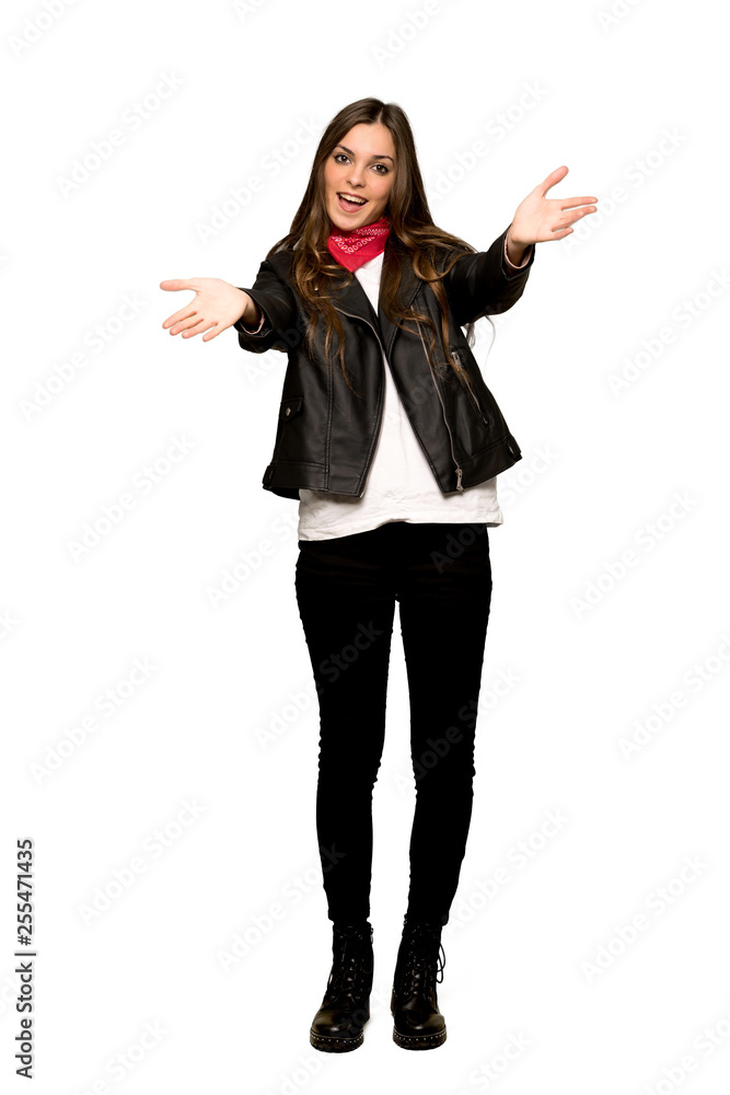 Full-length shot of Young woman with leather jacket presenting and inviting to come with hand on isolated white background Full-length shot of Young woman with leather jacket presenting and inviting to come with hand on isolated white background