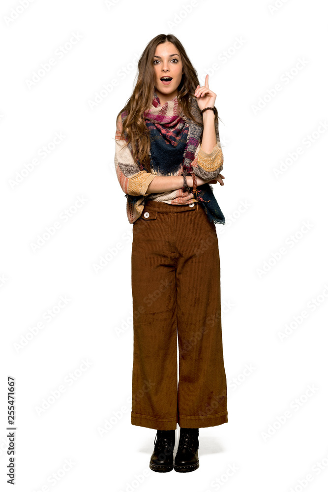 Full-length shot of Young hippie woman thinking an idea pointing the finger up on isolated white background Full-length shot of Young hippie woman thinking an idea pointing the finger up on isolated white background