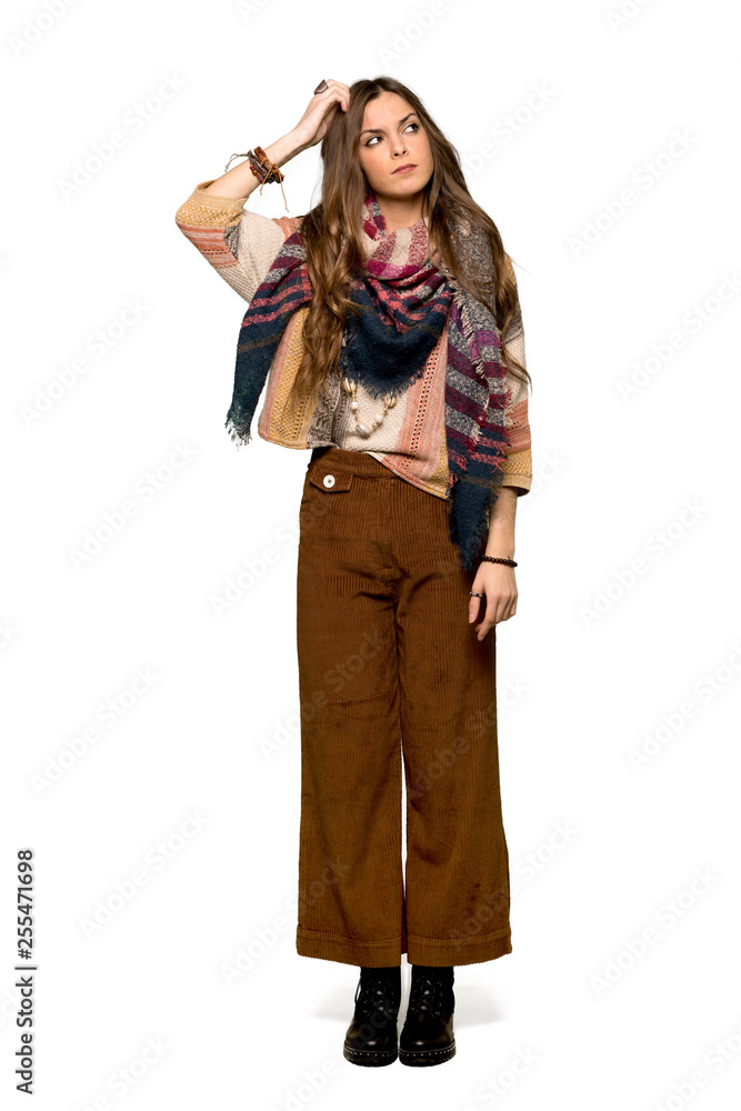 Full-length shot of Young hippie woman having doubts while scratching head on isolated white background Full-length shot of Young hippie woman having doubts while scratching head on isolated white background