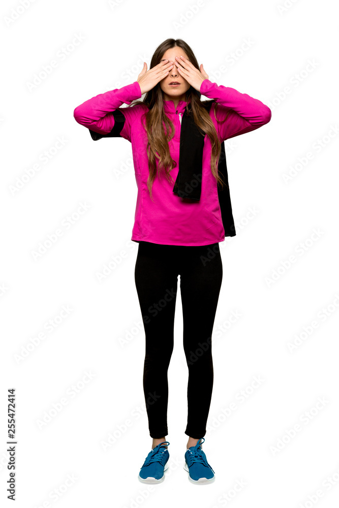 Fototapeta premium Full-length shot of Young sport woman covering eyes by hands. Surprised to see what is ahead over isolated white background