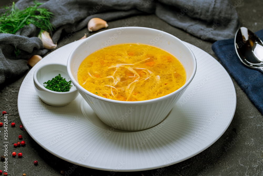 Chicken soup bouillon in a plate Chicken soup bouillon in a plate