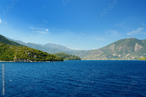Scenic view of Nidri port with boats and yachts passing by. Coast of Lefkada island on sunny summer day. © MNStudio