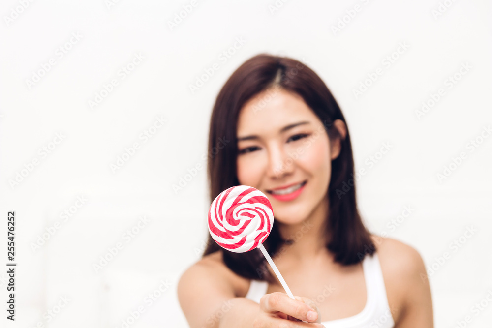 Portrait of sexy women holding big pink lollypop