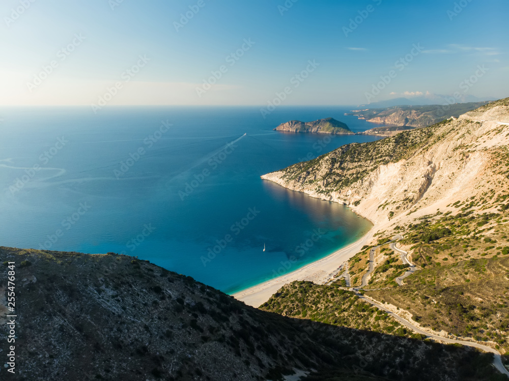Scenic aerial view of picturesque jagged coastline of Kefalonia with clear turquoise waters, surrounded by steep cliffs.