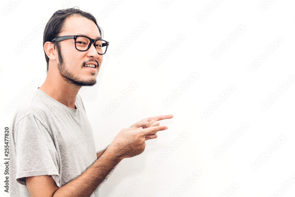 Portrait of happy smiling asian young handsome man pointing to empty copy space isolated on white background Portrait of happy smiling asian young handsome man pointing to empty copy space isolated on white background