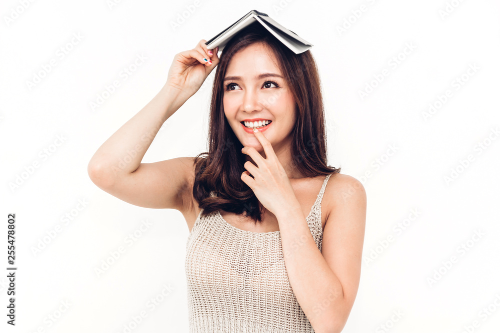 Portrait of female student holding book isolated on white background Portrait of female student holding book isolated on white background