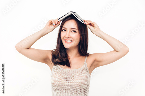 Portrait of female student holding book isolated on white background