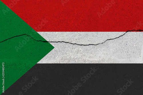 sudan flag on concrete wall with crack