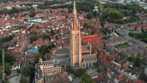 Gothic architecture of Bruges, Belgium at sunset - Church of Our Lady Bruges Aerial view of the Church of Our Lady Bruges, a Gothic church, founded in the 13th-century, known for its soaring tower & s