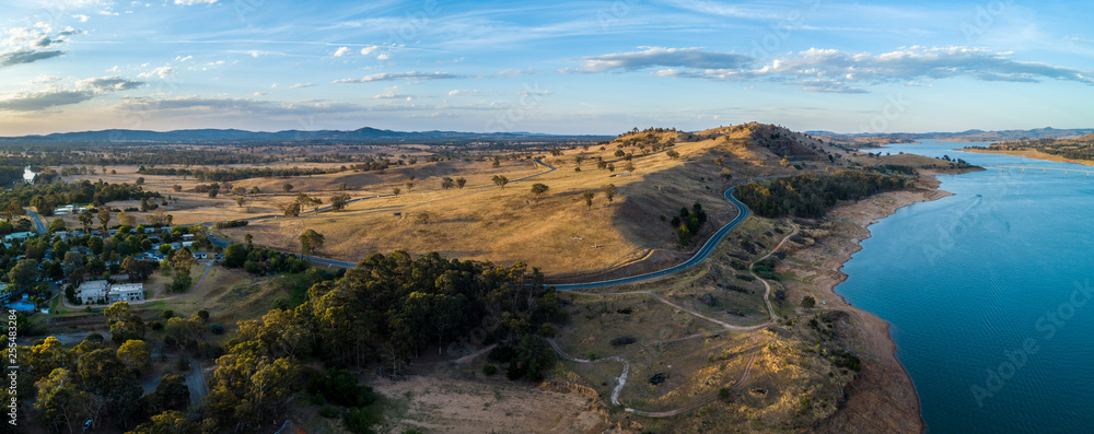 Scenic river and countryside rolling hills at sunset in Australia - aerial panorama
