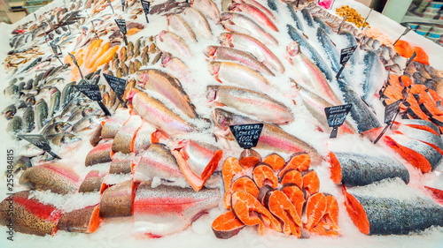 Photography a large selection of fresh fish lying in the ice on the counter of the supermarket