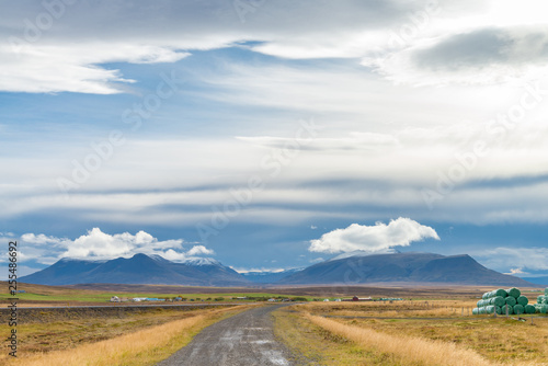 The road to volcanic mountain. Beautiful perspective view rural scene landscape in west Iceland.
