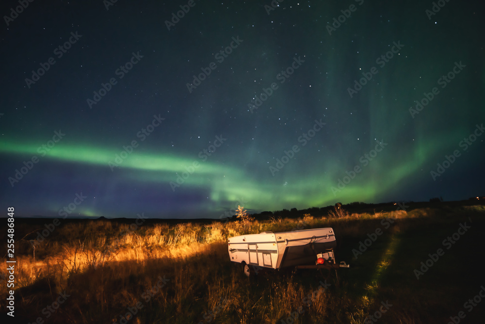 The supernatural northern aurora light in the meadow at camp ground near thingvellir national park Iceland.