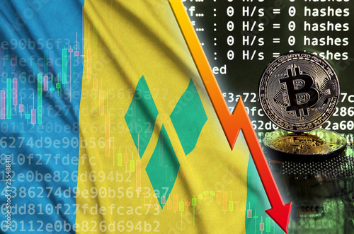 Saint Vincent and the Grenadines flag and falling red arrow on bitcoin mining screen and two physical golden bitcoins photo