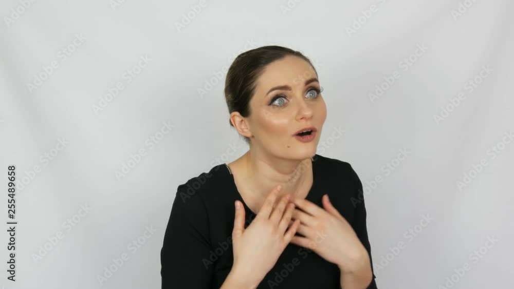 Portrait of a beautiful young elegant sexy girl who is emotionally surprised on a white background in the studio Portrait of a beautiful young elegant sexy girl who is emotionally surprised on a white background in the studio