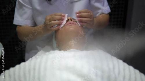 Wallpaper Mural woman client gets a spa treatment in the beauty salon, special face massage Torontodigital.ca