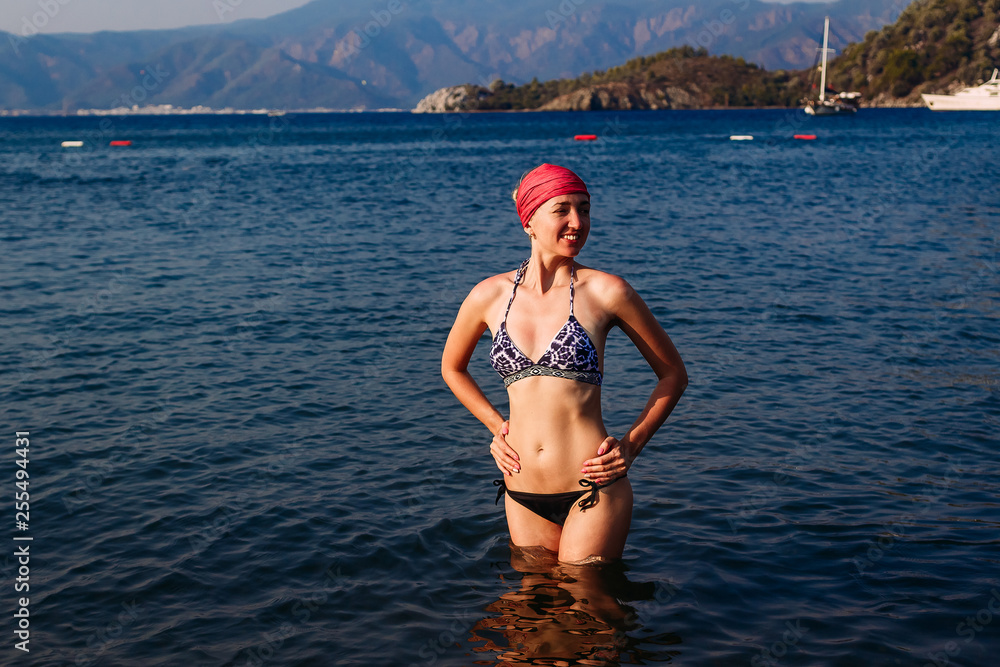a slender young woman in a bathing suit on sea in Turkey