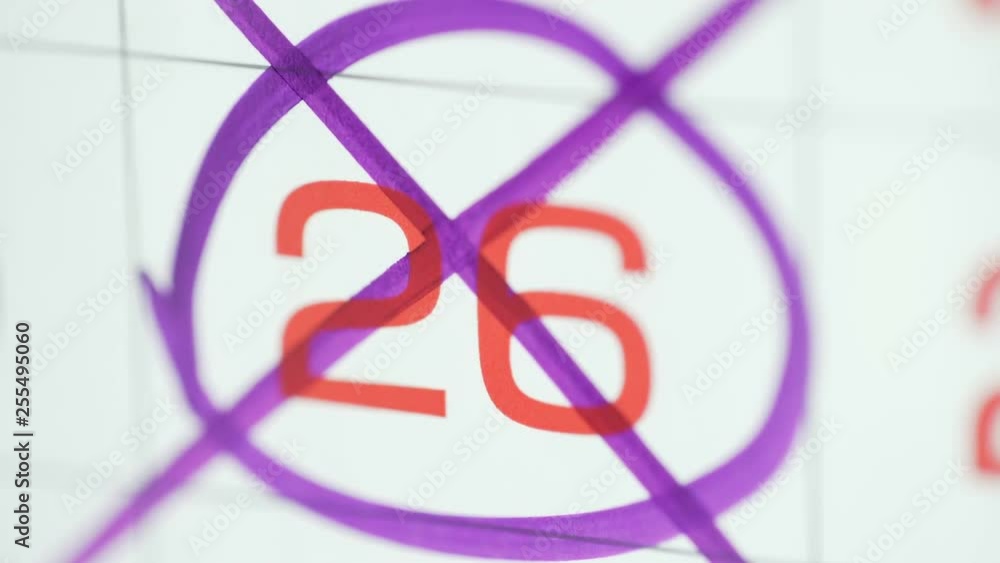 Woman hand cross day on paper calendar. 26st day of the month Woman hand cross day on paper calendar. 26st day of the month