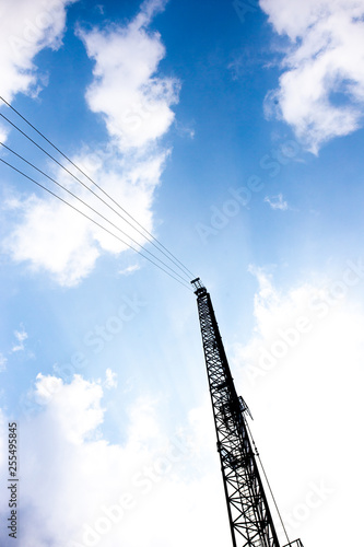 Construction crane against with blue sky and clouds