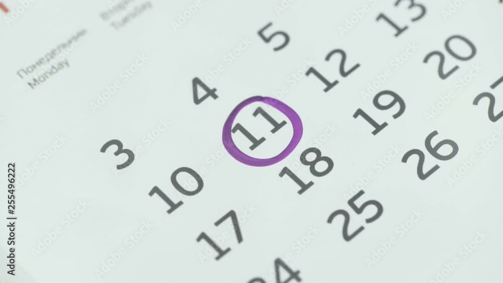 Woman hand circle day on paper calendar. 11st day of the month Woman hand circle day on paper calendar. 11st day of the month