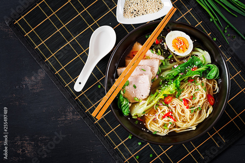 Fotografie Miso Ramen Asian noodles with egg, pork and pak choi cabbage in bowl on dark background