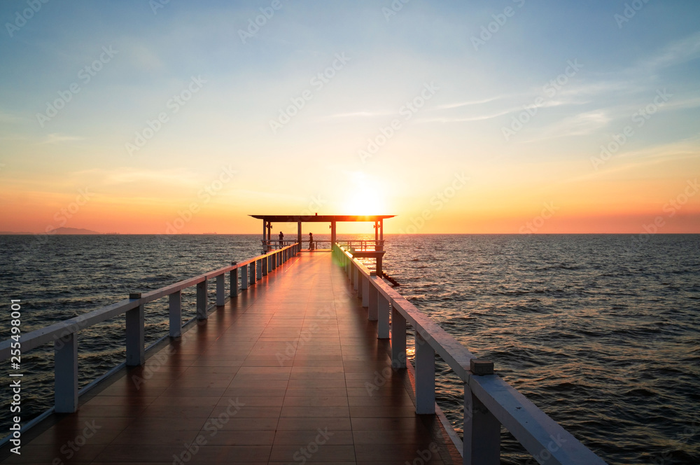 Landscape of bridge in sea on tropical beach and sunset sky background .