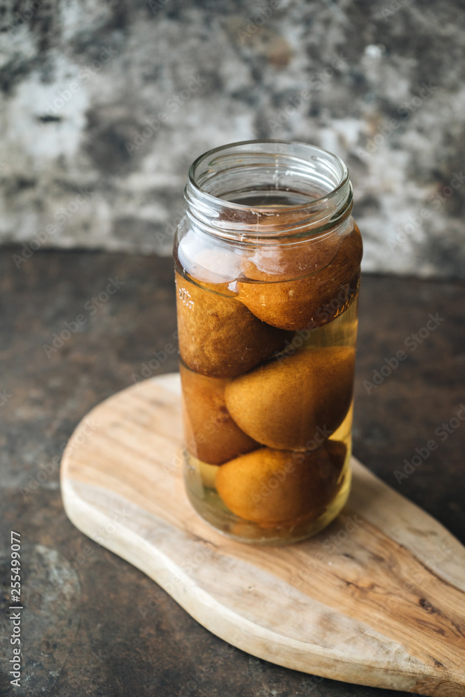Pickled lemon on rustic background Pickled lemon on rustic background