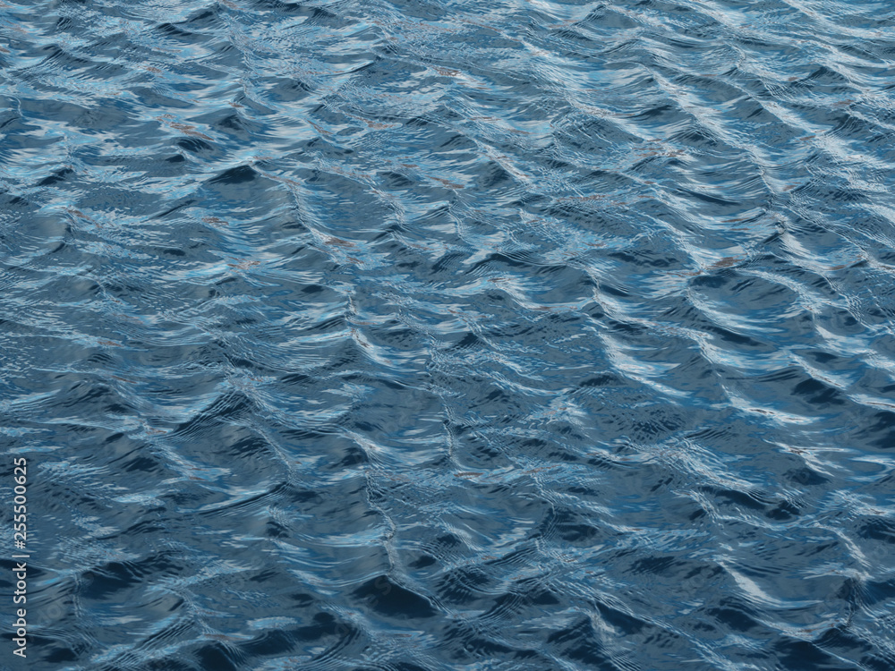 Water blue background. Ripples on blue water. Water blue background. Ripples on blue water.