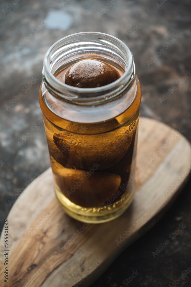 Pickled lemon on rustic background Pickled lemon on rustic background