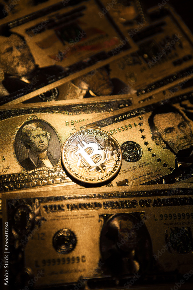 Bitcoin golden coin cryptocurrency on golden US dollar.