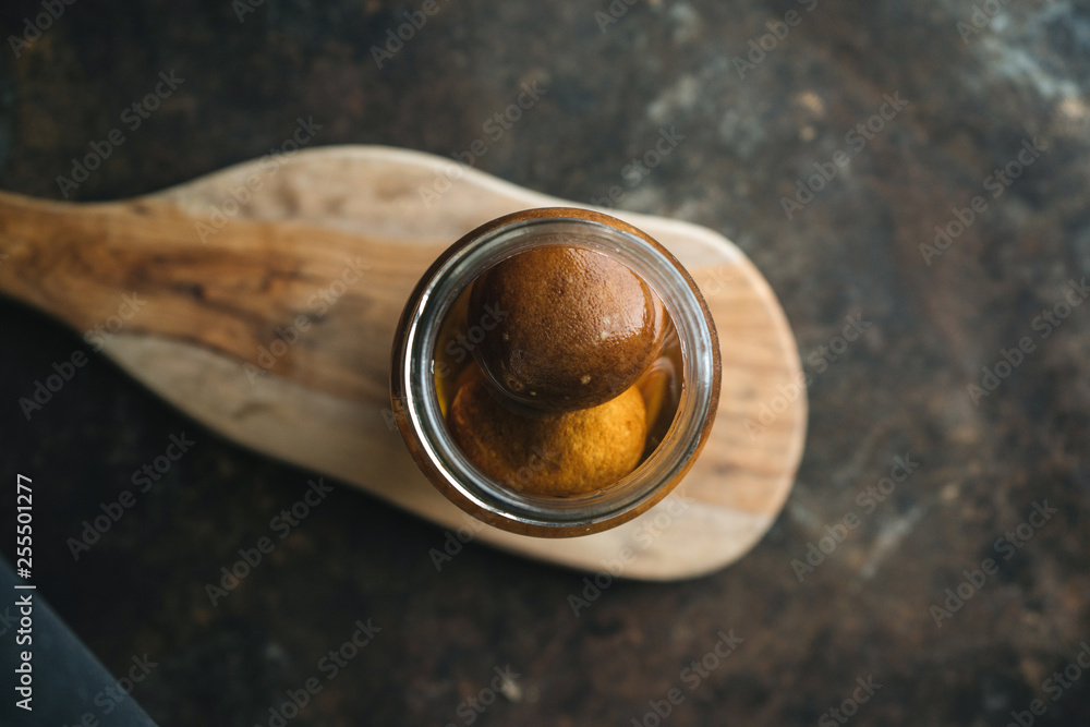 Pickled lemon on rustic background Pickled lemon on rustic background